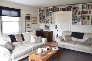 a living room with two couches and a coffee table at Bantham House, Bantham, South Devon - a few steps from golden sandy beaches in Bigbury on Sea