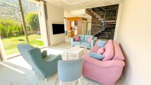 a living room with couches and chairs and a television at Villa w Pool Jacuzzi 5 min to Marina in Antalya in Finike