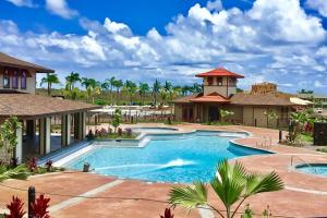 a pool at a resort with palm trees at Pili Mai 13C in Koloa