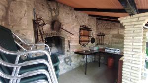 a stone room with a table and a fireplace at Los rosales in Burunchel +16 photos