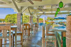 a restaurant with tables and chairs and a view of the ocean at Pili Mai 13C in Koloa