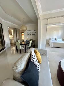 a living room with a couch and a dining room at Recoleta Luxury Apartment in Buenos Aires