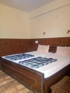 a large bed in a room with at Hotel Gyespa in Kyelang