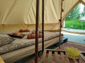 a bedroom with two beds in a tent at Magic forest 