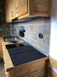 a kitchen with wooden cabinets and a sink at Ines’s Dream in Stelida