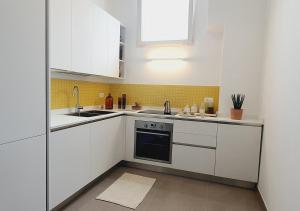 a kitchen with white cabinets and a sink at Casa con terrazza esclusiva su Nardò in Nardò