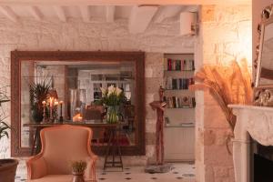 a living room with a mirror and a chair at Beyevi Alaçatı in Alaçatı