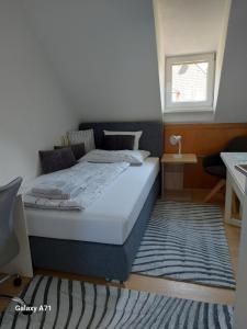 a bedroom with a bed with a rug and a window at Ferienhaus Käthe in Klagenfurt