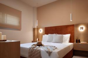 Postel nebo postele na pokoji v ubytování Chronos Hotel