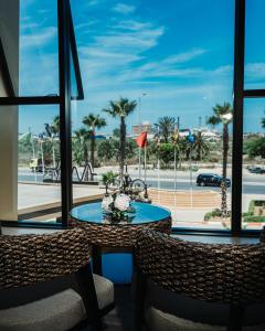 mesa y sillas con vistas a la playa en Waves Aqua Resort en Kenitra