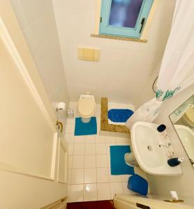 a small bathroom with a toilet and a sink at Piazza ginestre porto rotondo in Porto Rotondo