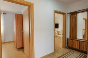 an empty room with a door and a mirror at Villa All Season in Sarandë
