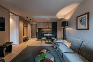 a living room and kitchen with a couch and a table at Sportony Mountain Lodges in La Villa