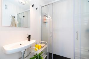 a white bathroom with a sink and a shower at Casa Bonita in Almería