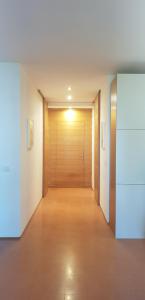a hallway with a wooden door in a building at Casale del Mare in Castiglioncello