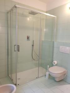 a bathroom with a shower with a toilet and a sink at Casale del Mare in Castiglioncello