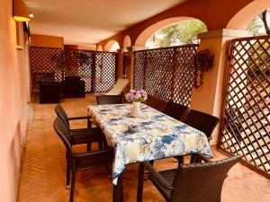 a table with chairs and a vase of flowers on it at Piazza ginestre porto rotondo in Porto Rotondo