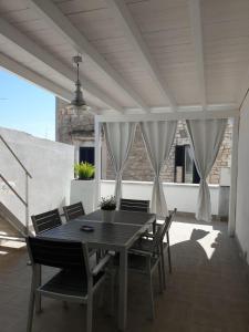 a dining table and chairs on a patio at Suite Sui Tetti Apartment in Bari