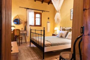 a bedroom with a bed and a desk and a window at Villa Pigadi Nikiti beach vacation in Metamorfosi