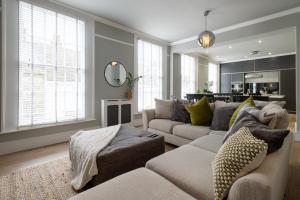 a living room with two couches and a table at Stylish Central Apartment with Parking & Lift in Bury Saint Edmunds