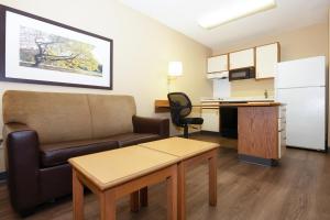 a living room with a couch and a table and a kitchen at Admiral Suites - Annapolis in Annapolis