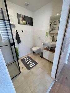 a bathroom with a toilet and a sink at Apartment Mirabelle 2 in Püttlingen