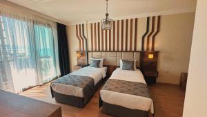 Postel nebo postele na pokoji v ubytování BİLİRİS HOTEL