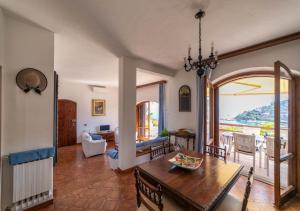 a living room with a table and a dining room at Super Terrace in Porto Santo Stefano