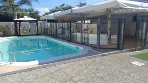 a swimming pool in a house with an umbrella at i girasoli srls in Bari