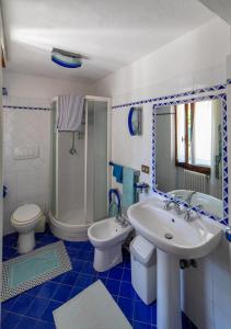 a bathroom with a sink and a toilet and a shower at Super Terrace in Porto Santo Stefano +33 photos