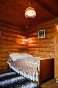 a bedroom with a bed in a log cabin at Luha Talu 