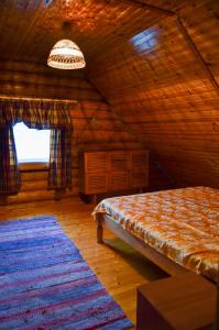 a bedroom with a bed in a wooden cabin at Luha Talu in Rebaste