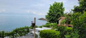 a white bench sitting next to the water at Trabzon Villa in Trabzon