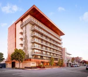 a rendering of a large apartment building with a pointed roof at Nobu Hotel Palo Alto in Palo Alto