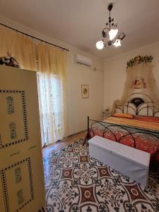 a bedroom with a bed and a table in a room at La Casa di Baldo in Ugento