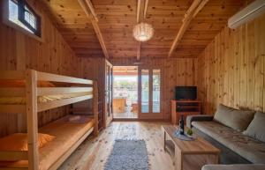 a living room with a bunk bed and a couch at Kucica Janja in Ulcinj