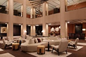 a lobby with a couch and tables and chairs at Nobu Hotel London Portman Square in London