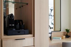 a wooden cabinet with a mirror in a room at Nobu Hotel London Portman Square in London