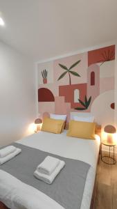 a bedroom with a large white bed with yellow pillows at Terracotta - T2 avec Terrasse proche de Cassis in Roquefort-la-Bédoule