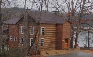 a large wooden house in the woods at White Oak Point on Lake Lure in Lake Lure