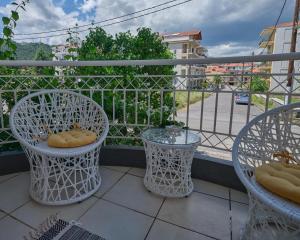 a balcony with two chairs and a table and a view at comfort apartment in Tripoli
