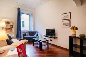 a living room with a couch and a tv at Santa Chiara Apartment by Wonderful Italy in Genova