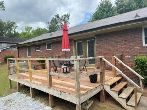 a wooden deck with a table and an umbrella at Brookwood in Chattanooga