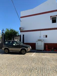 a car parked in front of a gas station at Apartamento Cañebolo in La Puebla de los Infantes