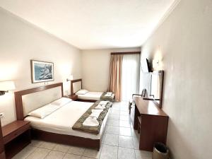 a hotel room with a bed and a desk at Hotel Ioni in Paralia Katerinis