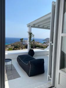 a balcony with a couch and a view of the ocean at Villa Anna in Elia Beach