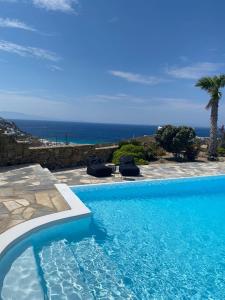 a swimming pool with a view of the ocean at Villa Anna in Elia Beach