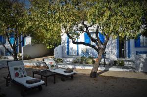 two chairs and a table under a tree at Summer Residence in Provatas