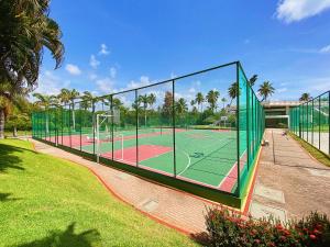 a tennis court with two tennis courts at Beach Class Resort - Muro Alto Bangalô in Porto De Galinhas