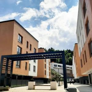 a blue metal structure in front of some buildings at Sova studio apartment Bjelasnica in Bjelašnica